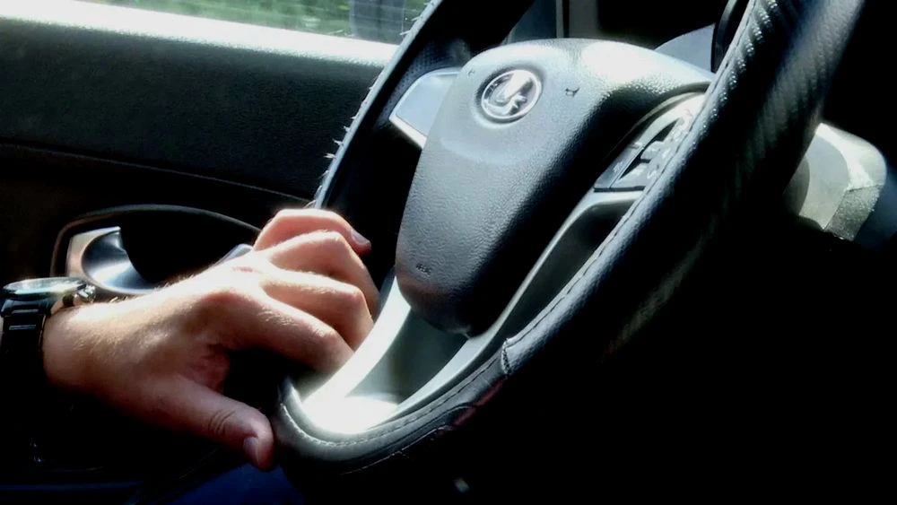 салон автомобиля, за рулем водитель