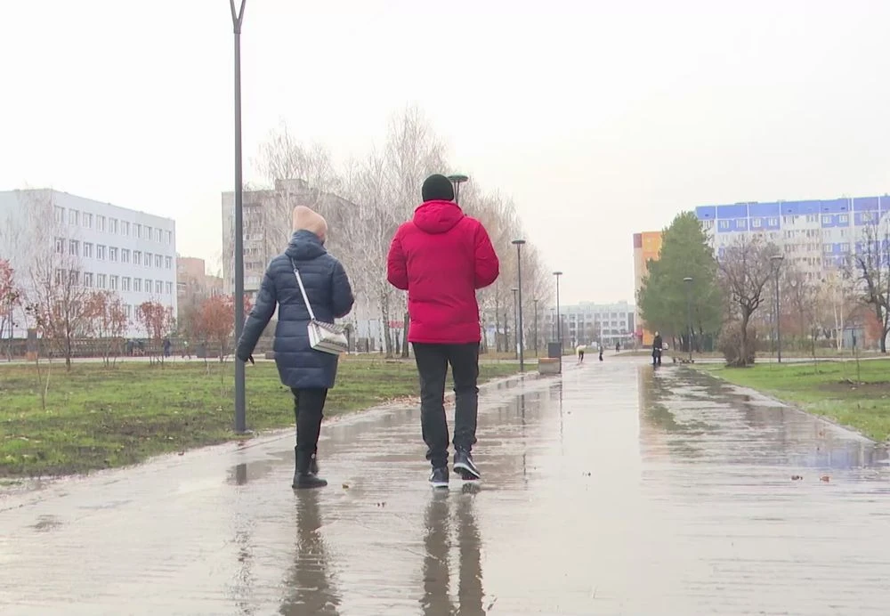 мужчина и женщина идут по тротуару осенью в нижнекамске