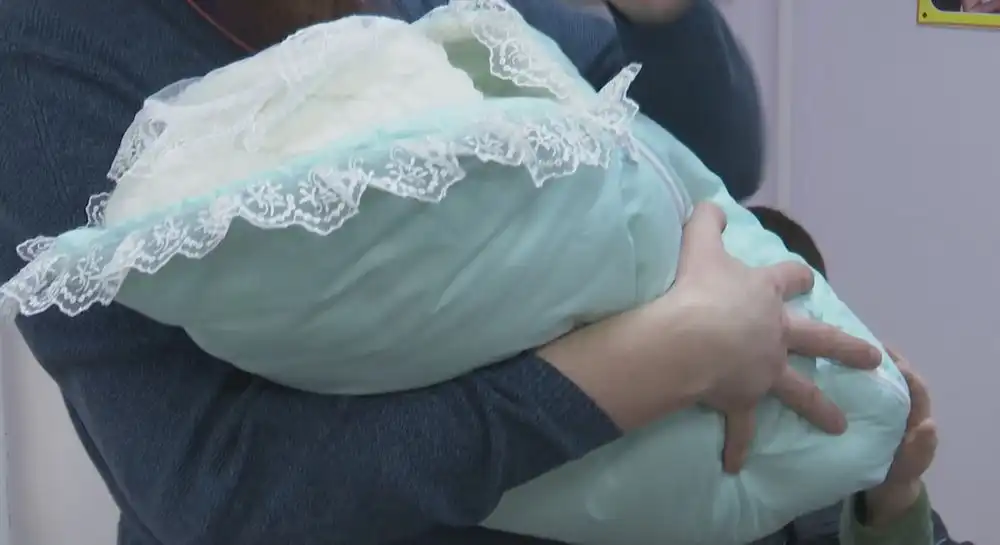 мать с новорожденным ребенком на руках