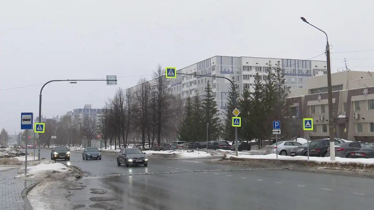 Машины едут по городской автомобильной дороге в пасмурную погоду