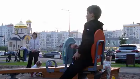 мальчик качается на качелях
