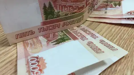 Пятитысячные купюры Банка России лежат на столе