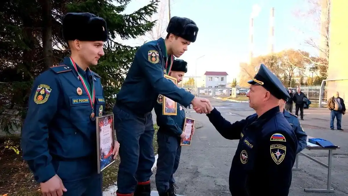 пожарный из Нижнекамска Кирилл Исаев получает награду после конкурса